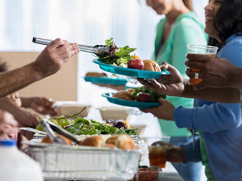 Group of people lined up to be served food